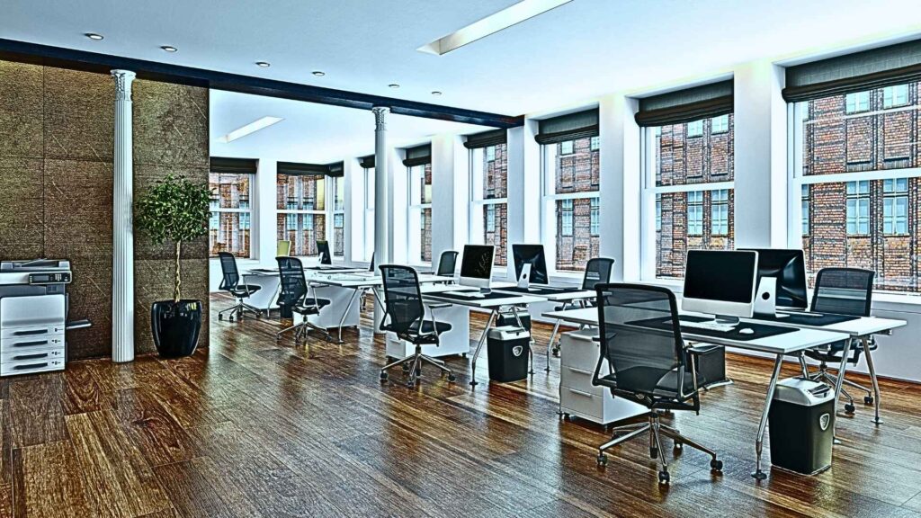 A picture of several empty chairs behind tables in an office used to describe a nonprofit's backstage.