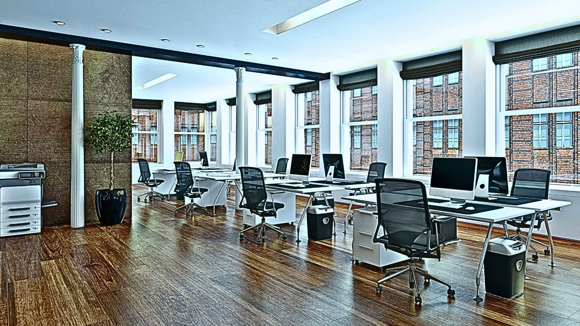 A picture of several empty chairs behind tables in an office used to describe a nonprofit's backstage.